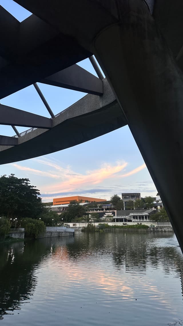 a body of water with a bridge and buildings in the background